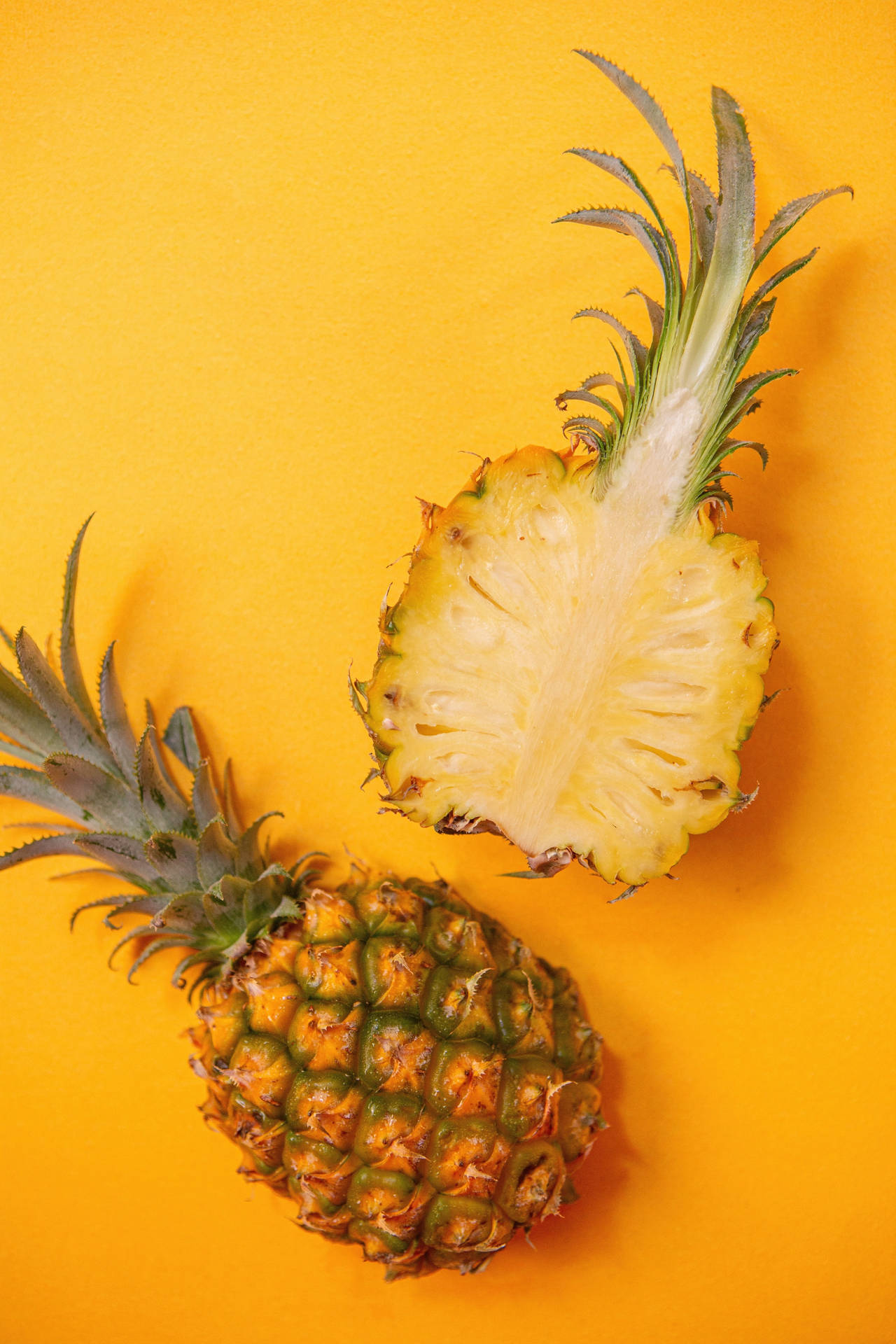 Vibrant Iphone Wallpaper Showcasing A Single Pineapple On A Yellow Background Background