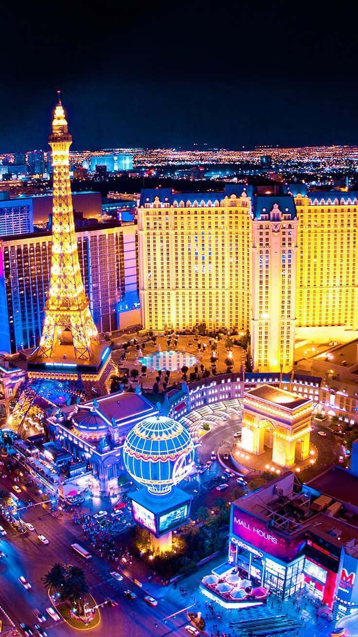 Vibrant Las Vegas Cityscape At Night Through A Mobile Screen Background