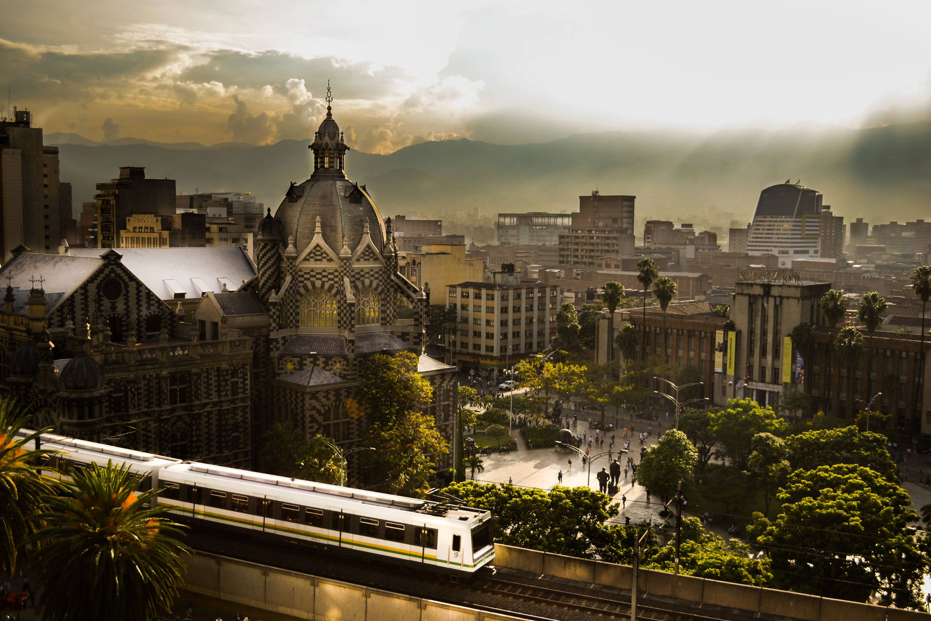 Vibrant Medellin Cityscape With Metro View Background