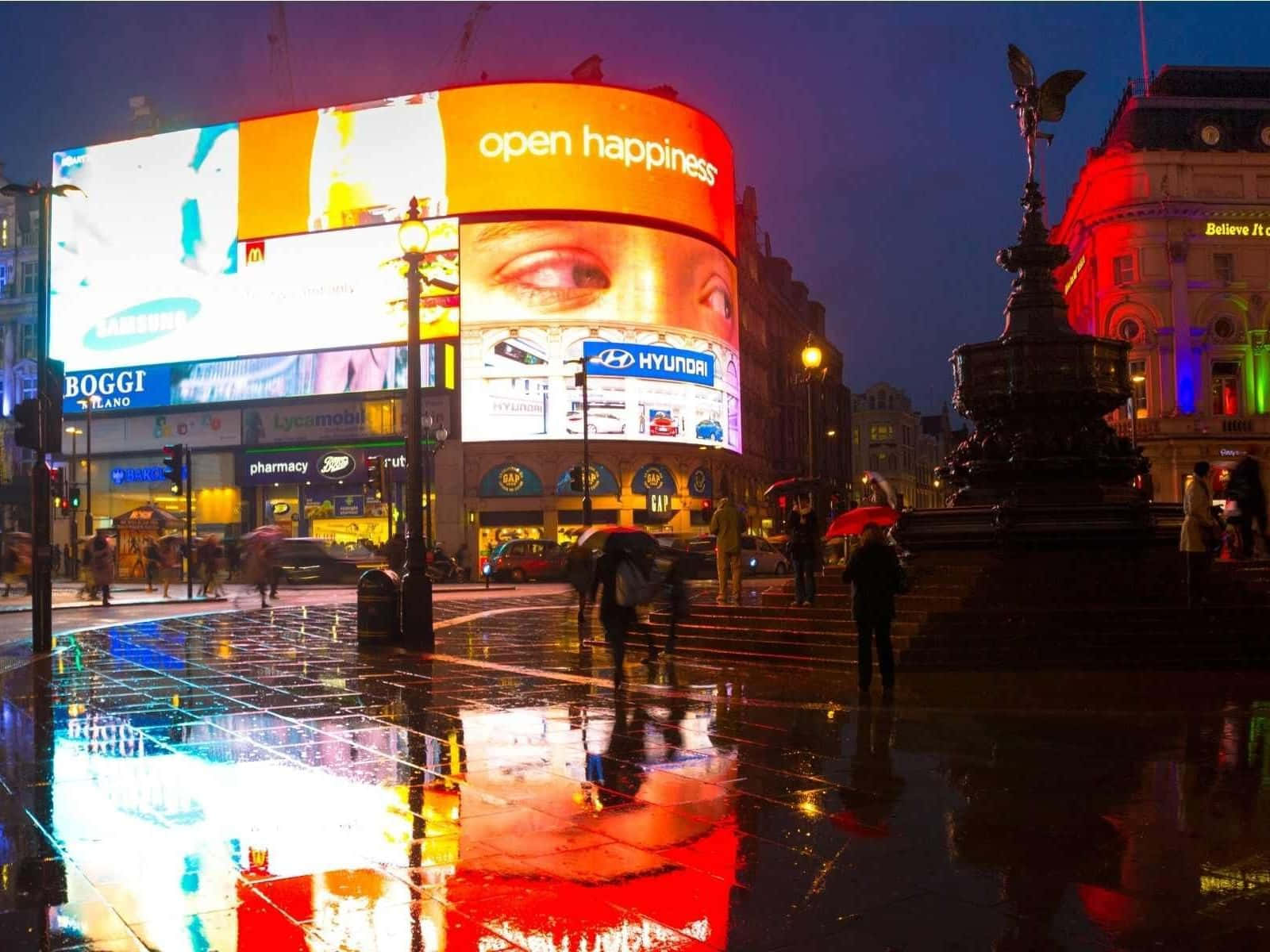 Vibrant Piccadilly Circus With Wet Floor Background