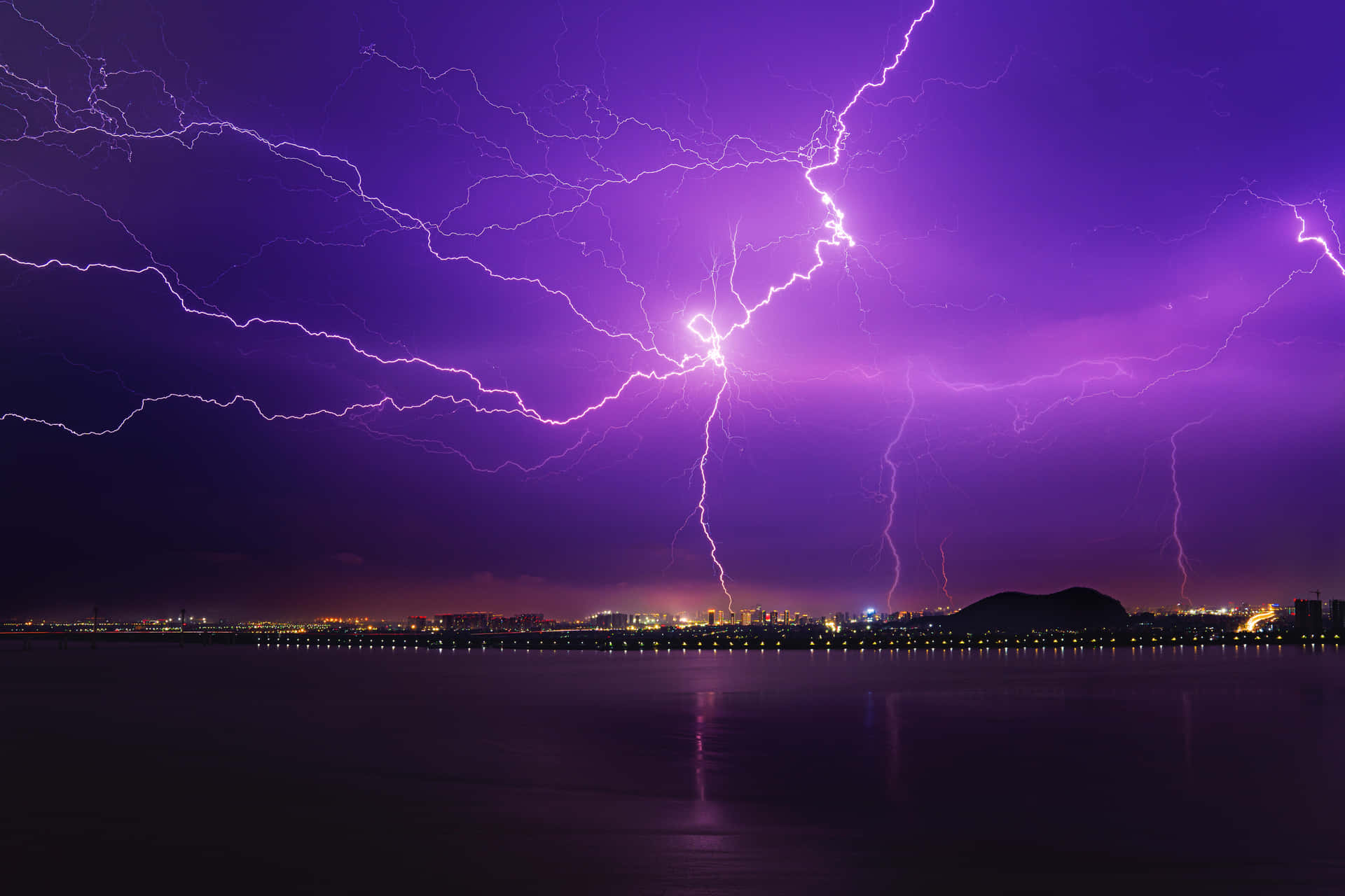 Vibrant Purple Lightning Over City Background