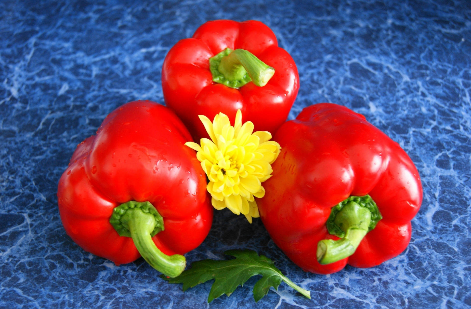 Vibrant Red Bell Pepper Besieged By Yellow Dahlias Background