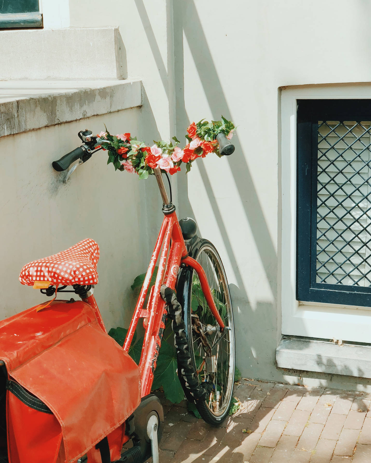 Vibrant Red Bike Adorned With Fresh Flowers Background