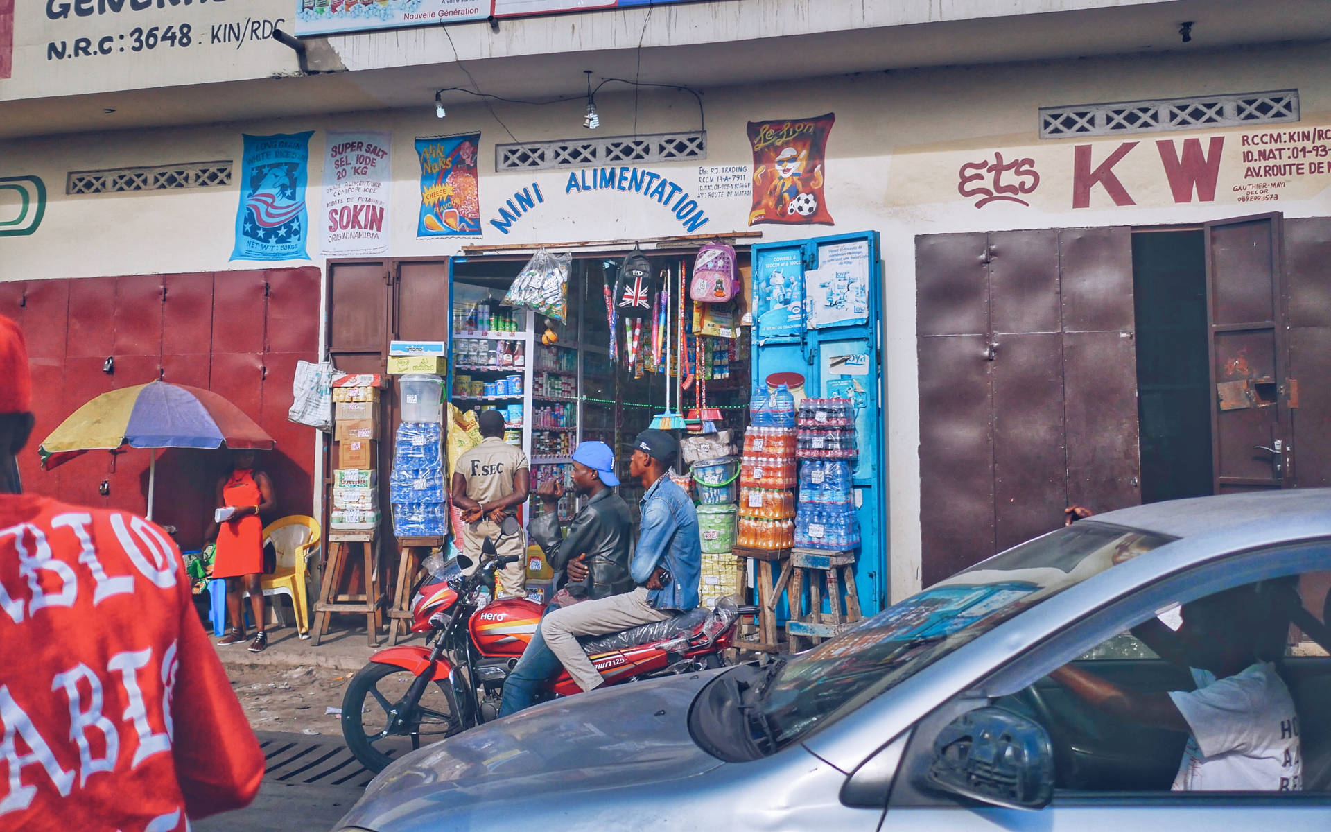 Vibrant Shop Scene In Kinshasa, Congo Background