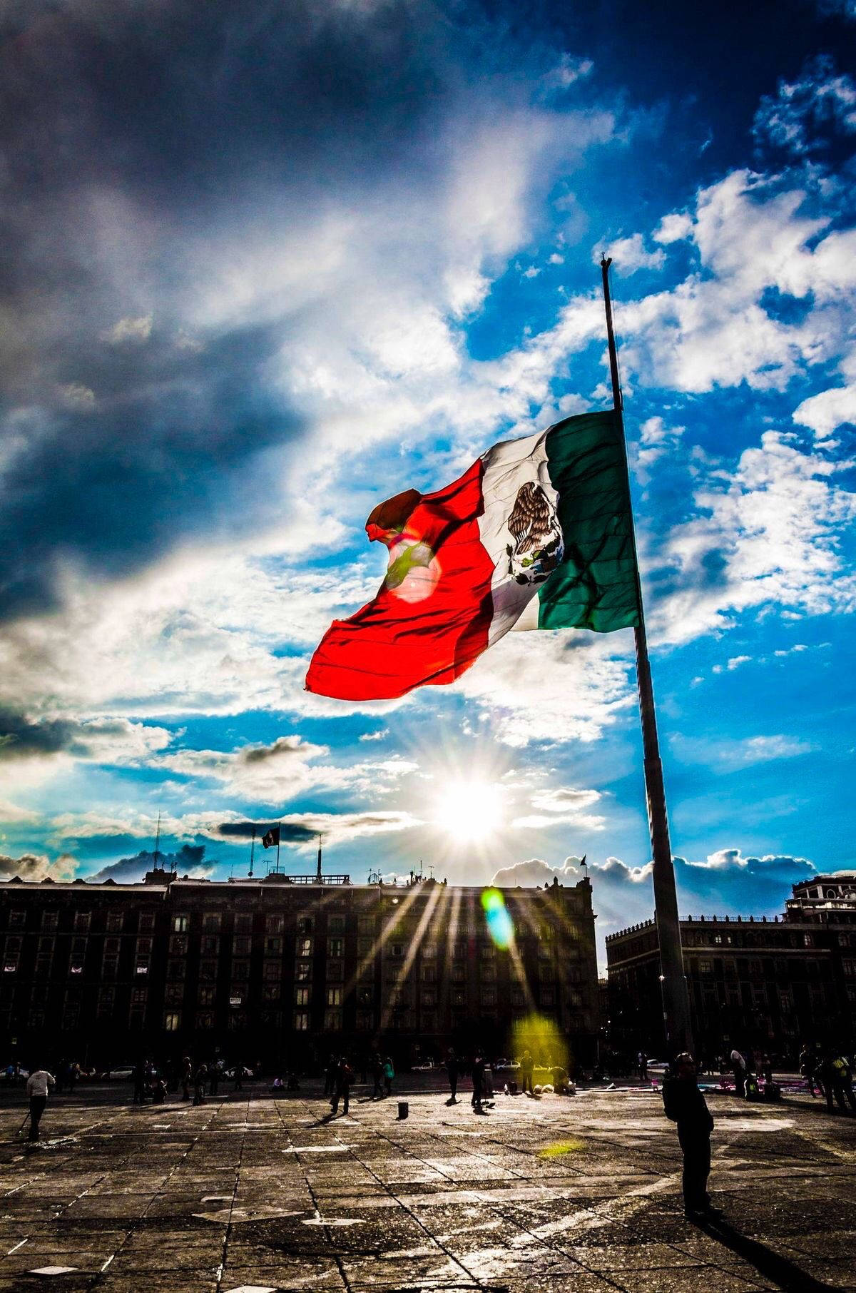 Vibrant Skies Above Mexico Flag Background