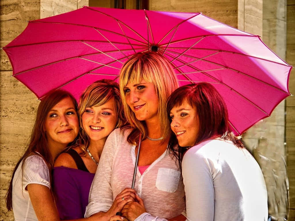 Vibrant Umbrella Four Women Smiling Background