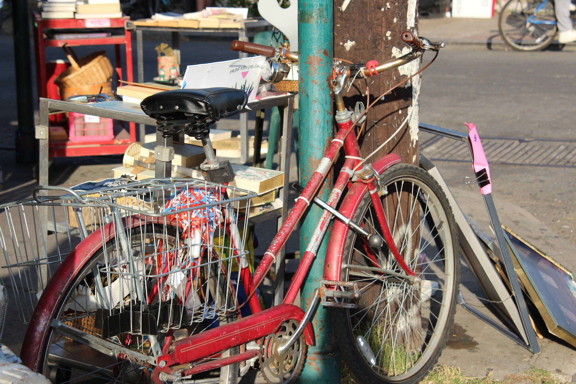 Vibrant Urban Red Bike On A Paved Street Background