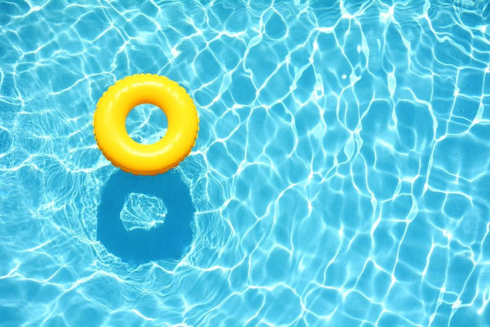 Vibrant Yellow Ring Floating On Tranquil Pool Water