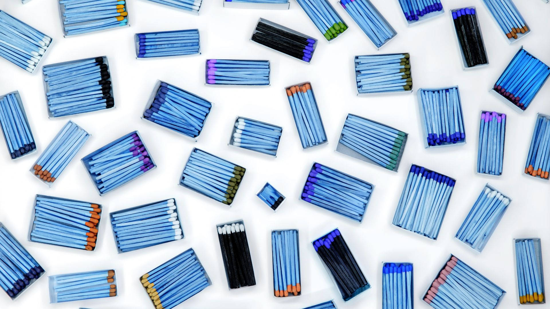 Vibrantly Colored Matchstick Tips Arranged In A Row. Background