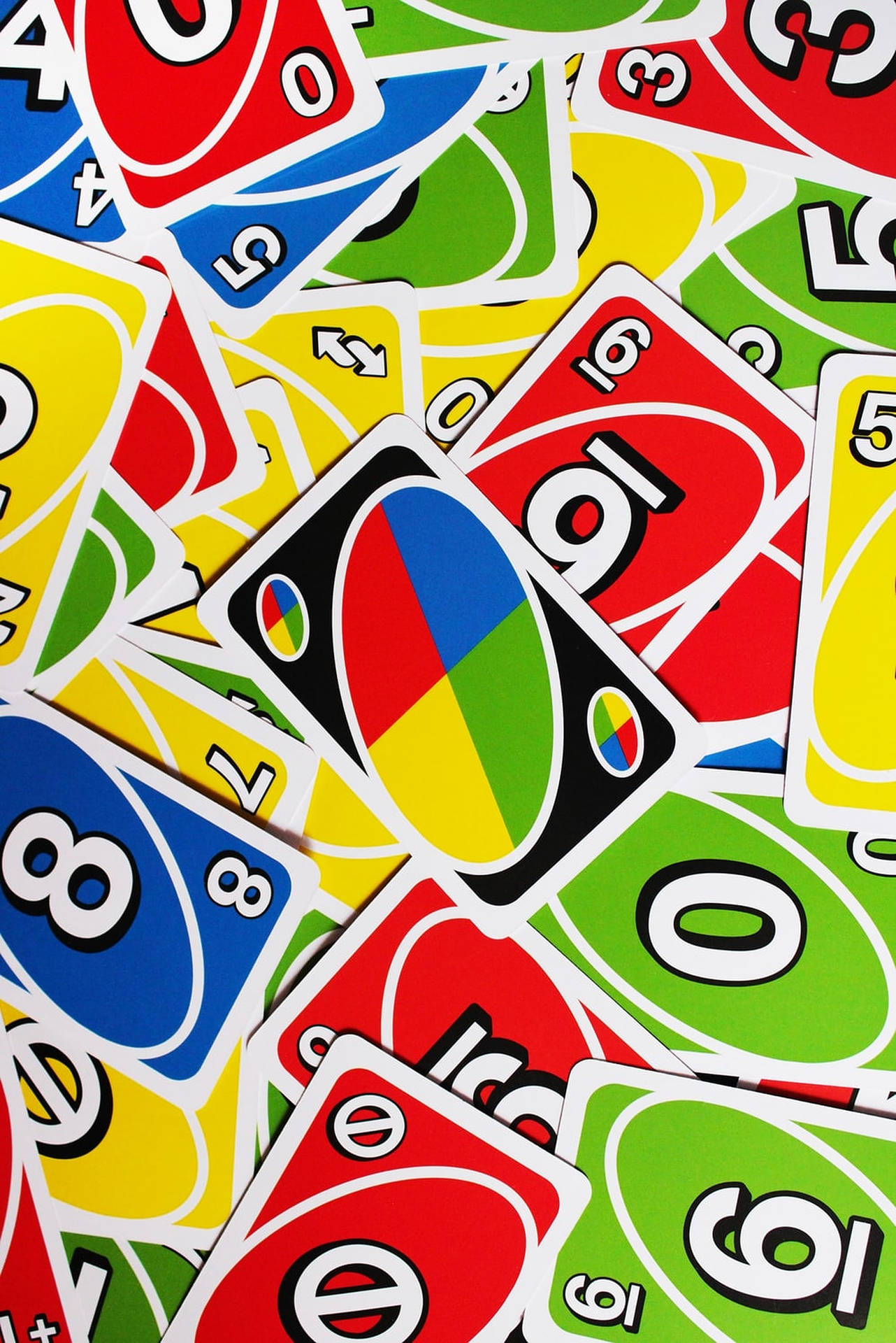 Vibrantly Colored Uno Cards Spread Out Background