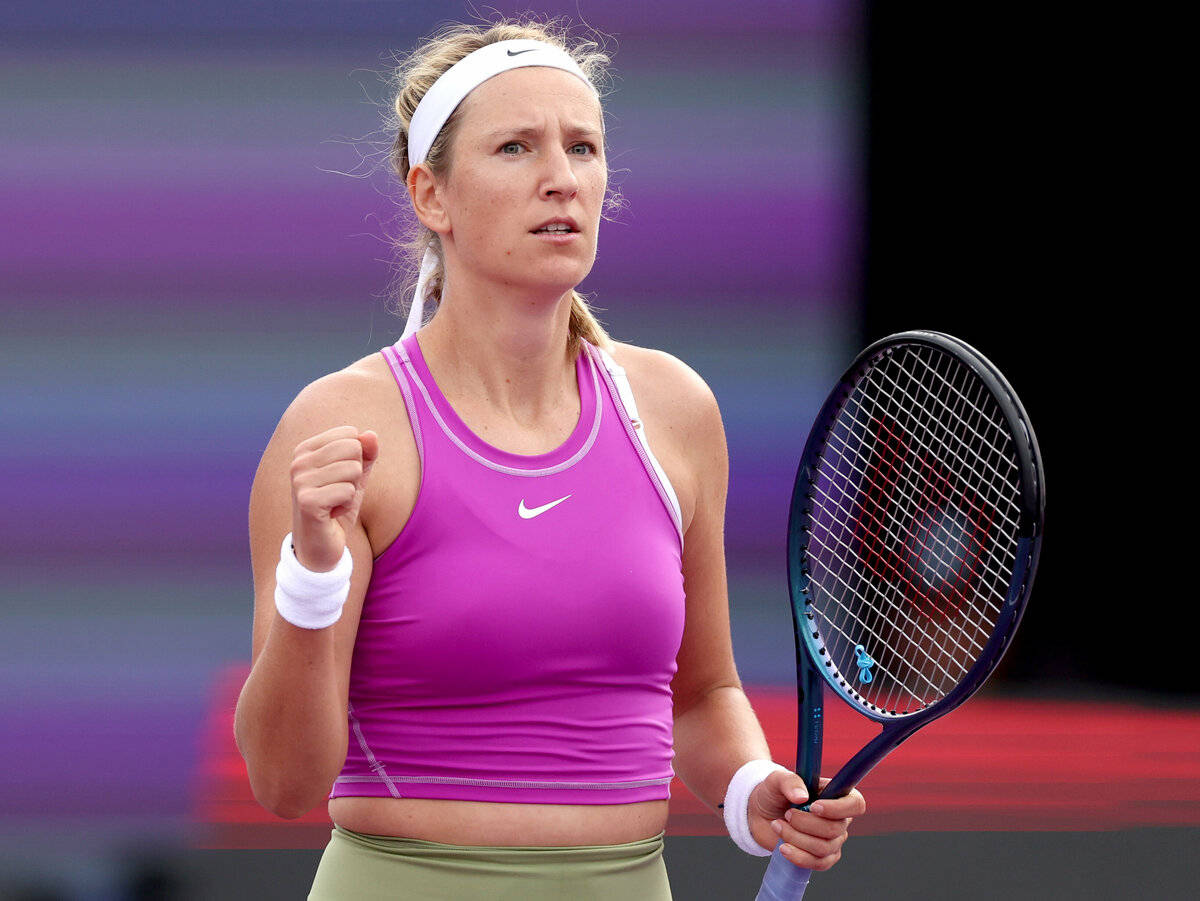 Victoria Azarenka In Purple Raising Racket Background