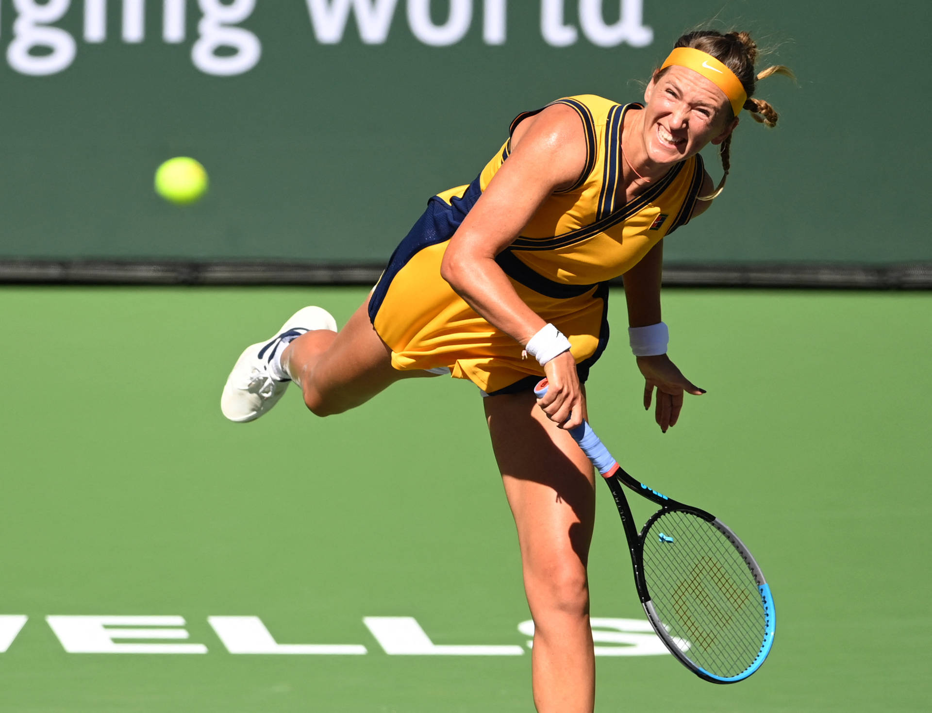 Victoria Azarenka Swinging Racket In Yellow Background