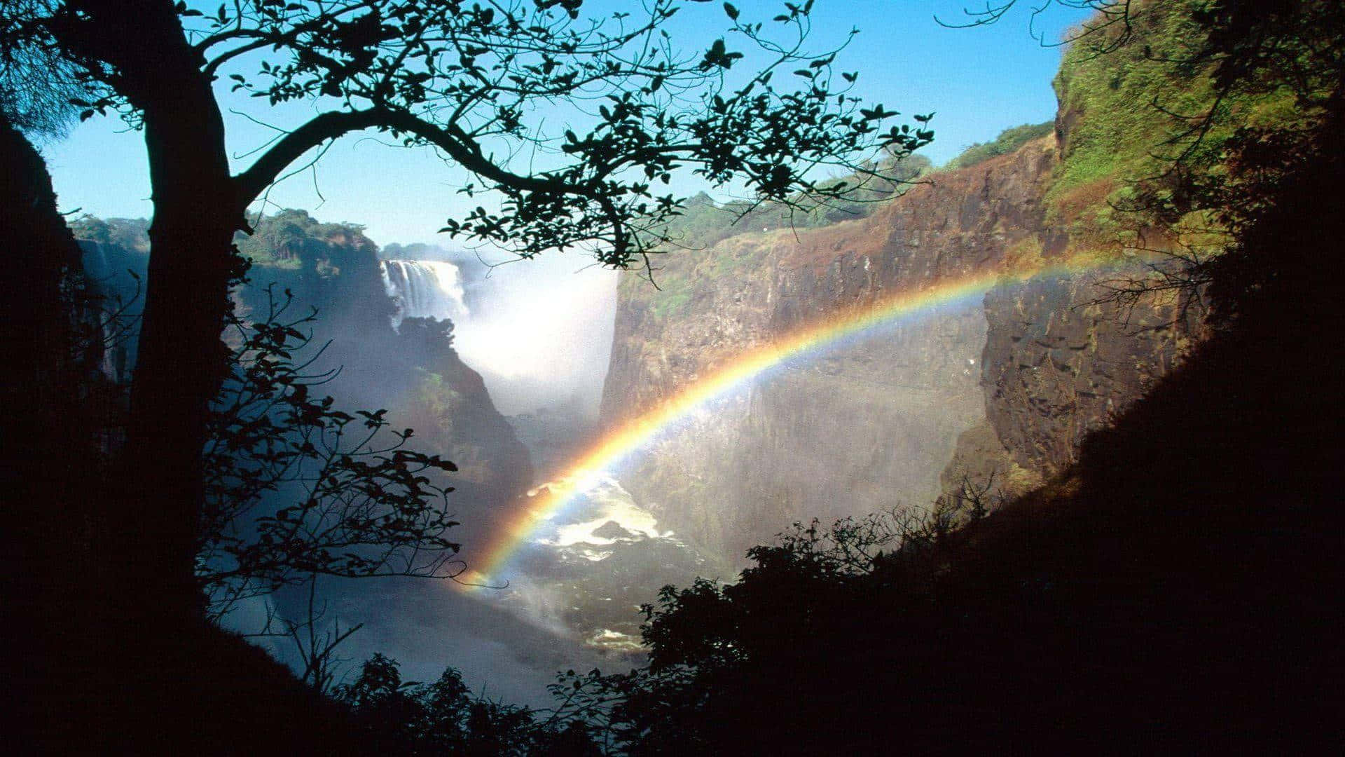 Victoria Falls With A Shining Rainbow Background