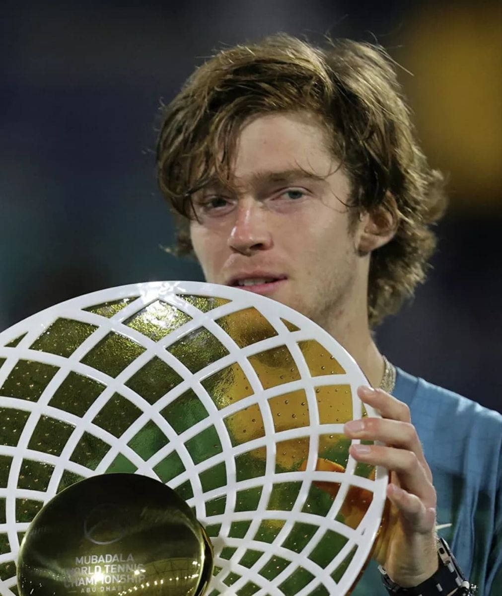 Victorious Moment: Andrey Rublev Holding The Tennis Championship Trophy Background