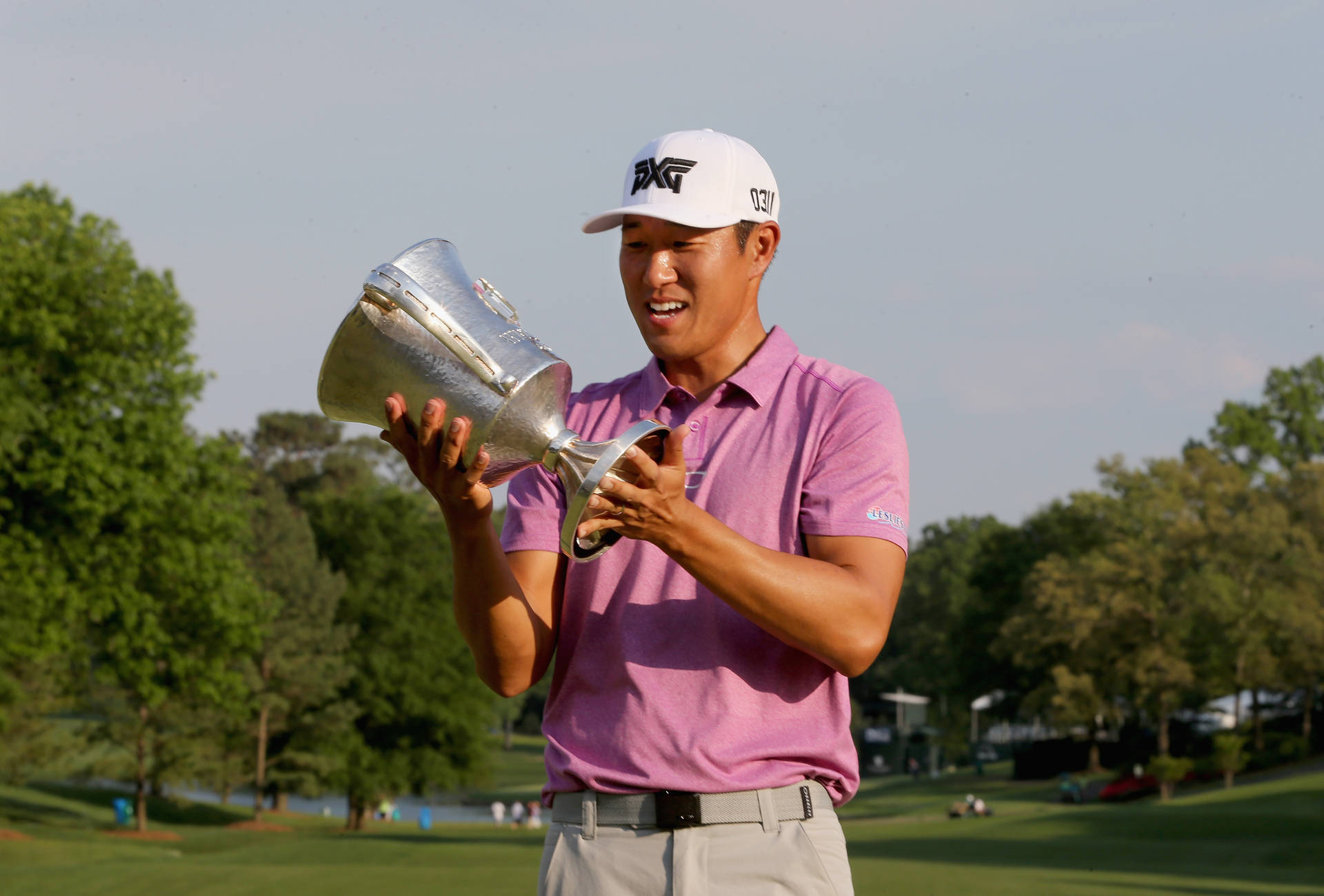 Victorious Moment: James Hahn Holding Trophy Background