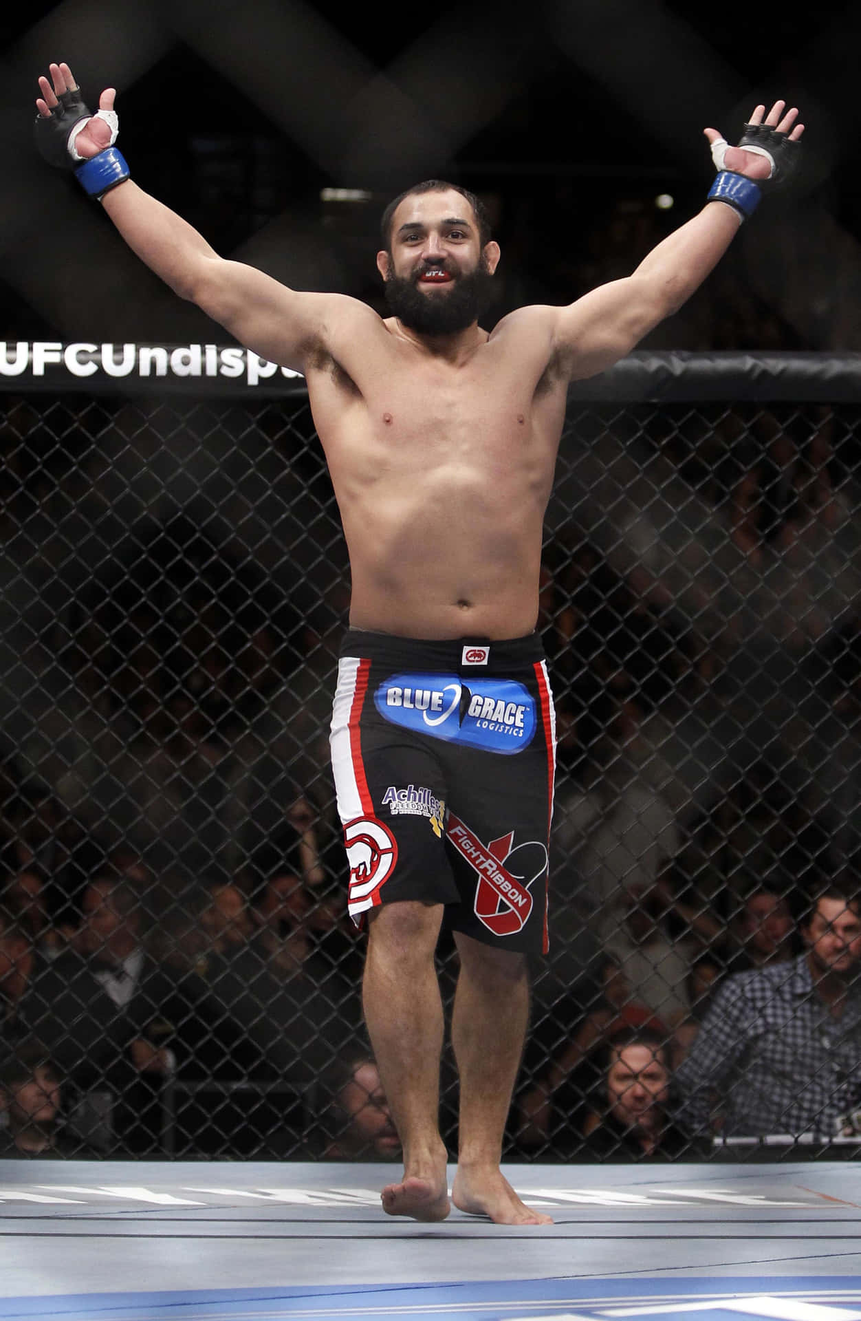 Victorious Moment – Johny Hendricks Celebrating His Win In The Octagon Background