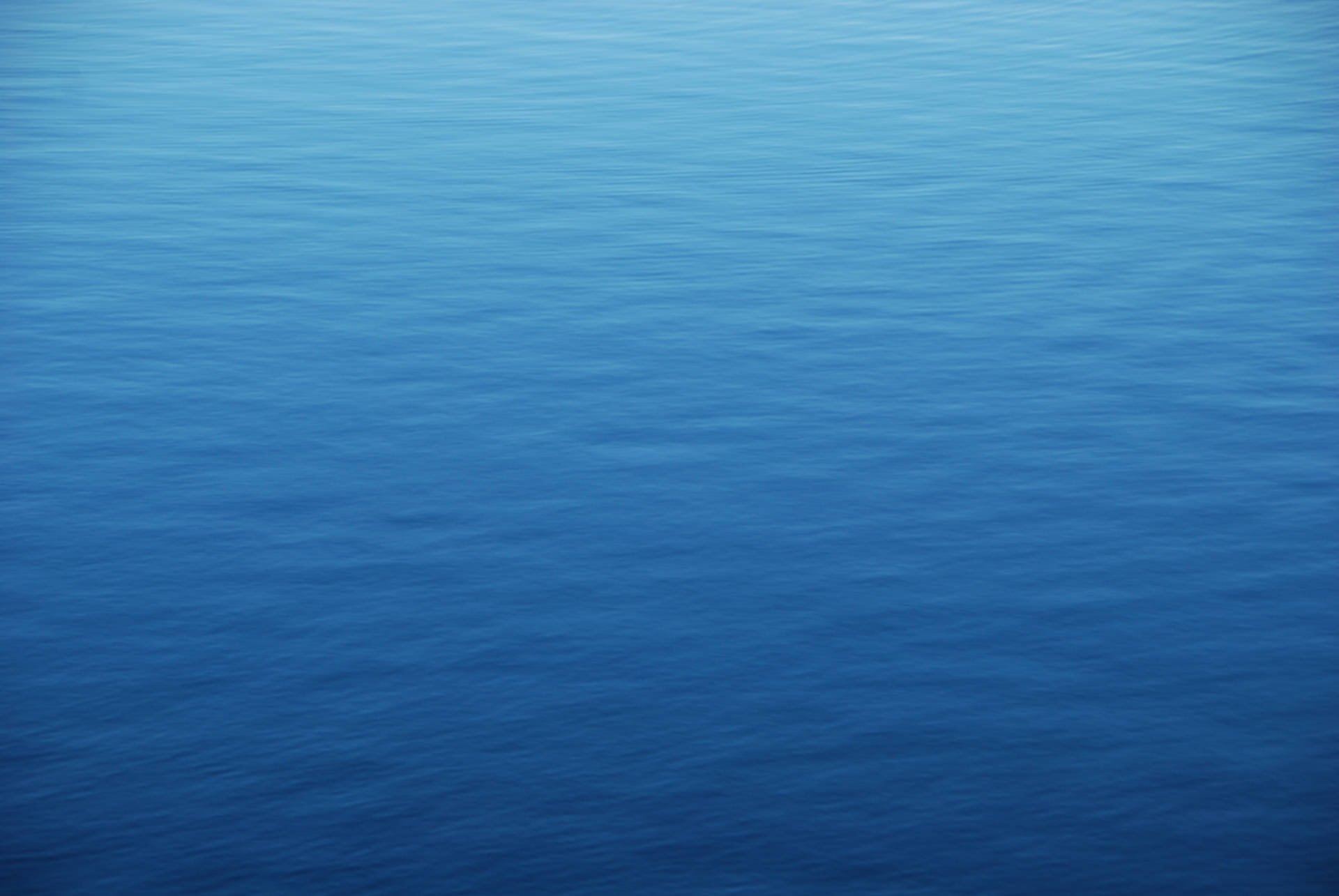 View From Above Of The Calm Blue Ocean Water Background