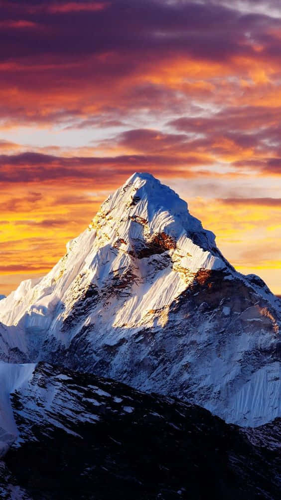 View Of A Mountain Range Under A Pink And Purple Dusk Sky Background