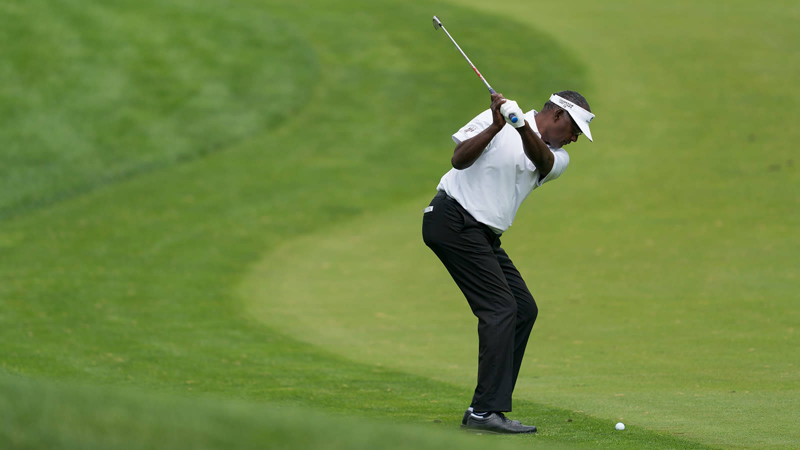 Vijay Singh Playing Golf On Course Background