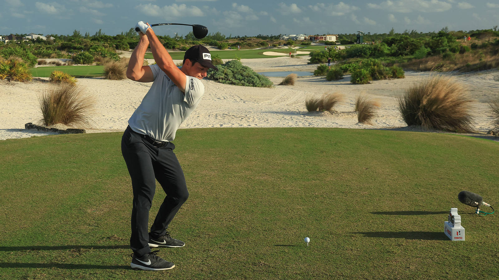 Viktor Hovland Striking The Ball Background