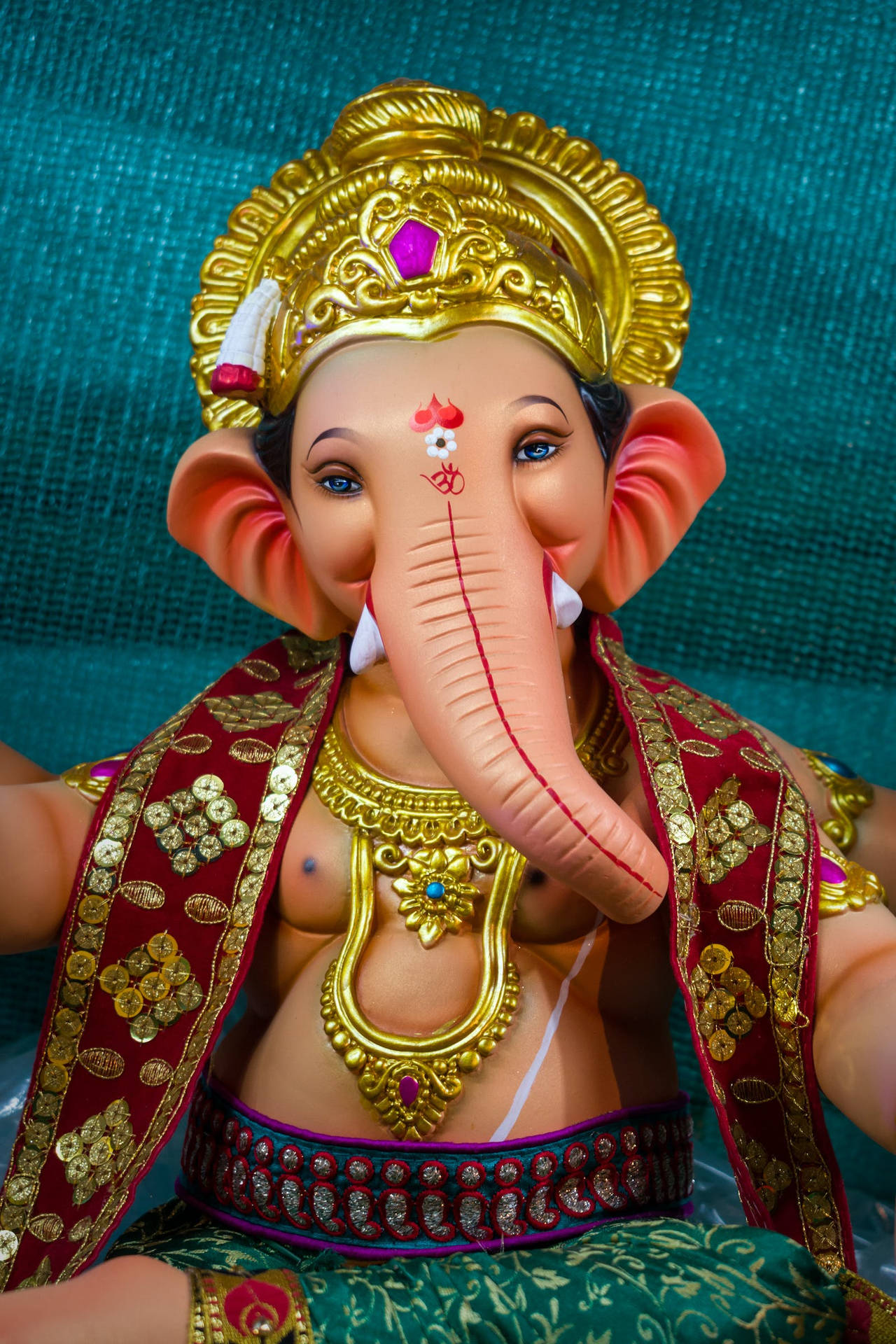 Vinayaka In Red And Blue Clothes Background