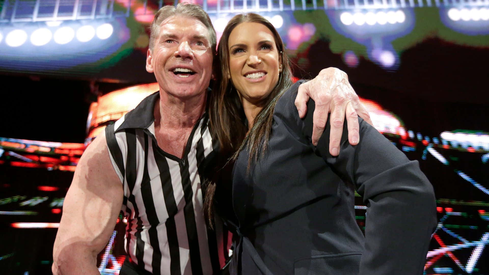 Vince Mcmahon And Stephanie Mcmahon Share A Moment Together Background