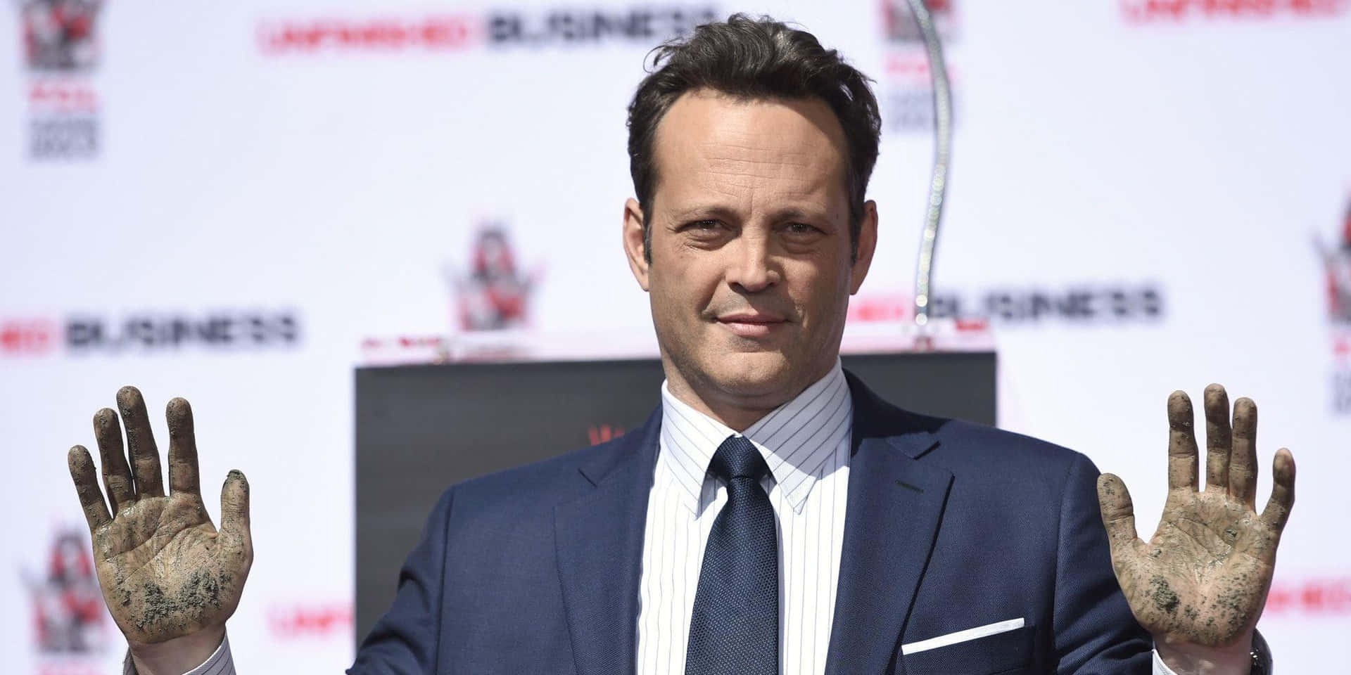Vince Vaughn Striking A Confident Pose During A Photoshoot Background