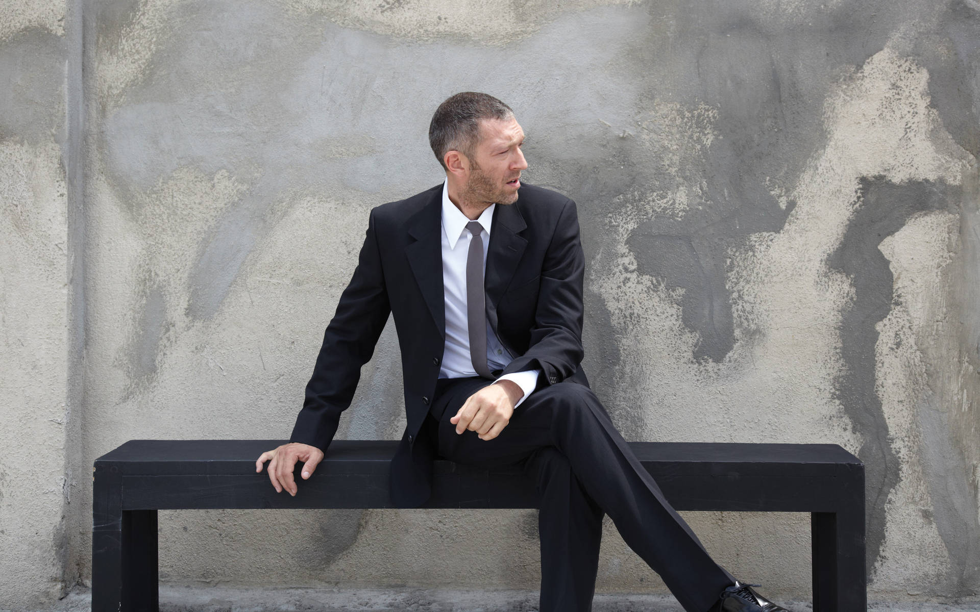 Vincent Cassel Sitting On Bench