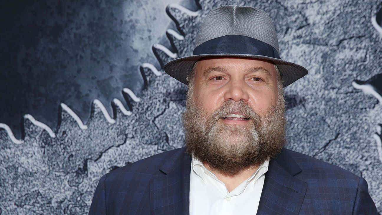 Vincent D'onofrio Exuding Confidence Against A Cityscape Backdrop Background