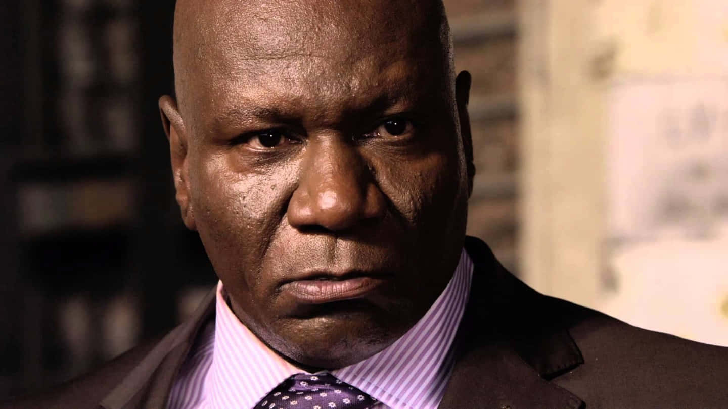 Ving Rhames Posing For A Photo Shoot Against A White Background Background