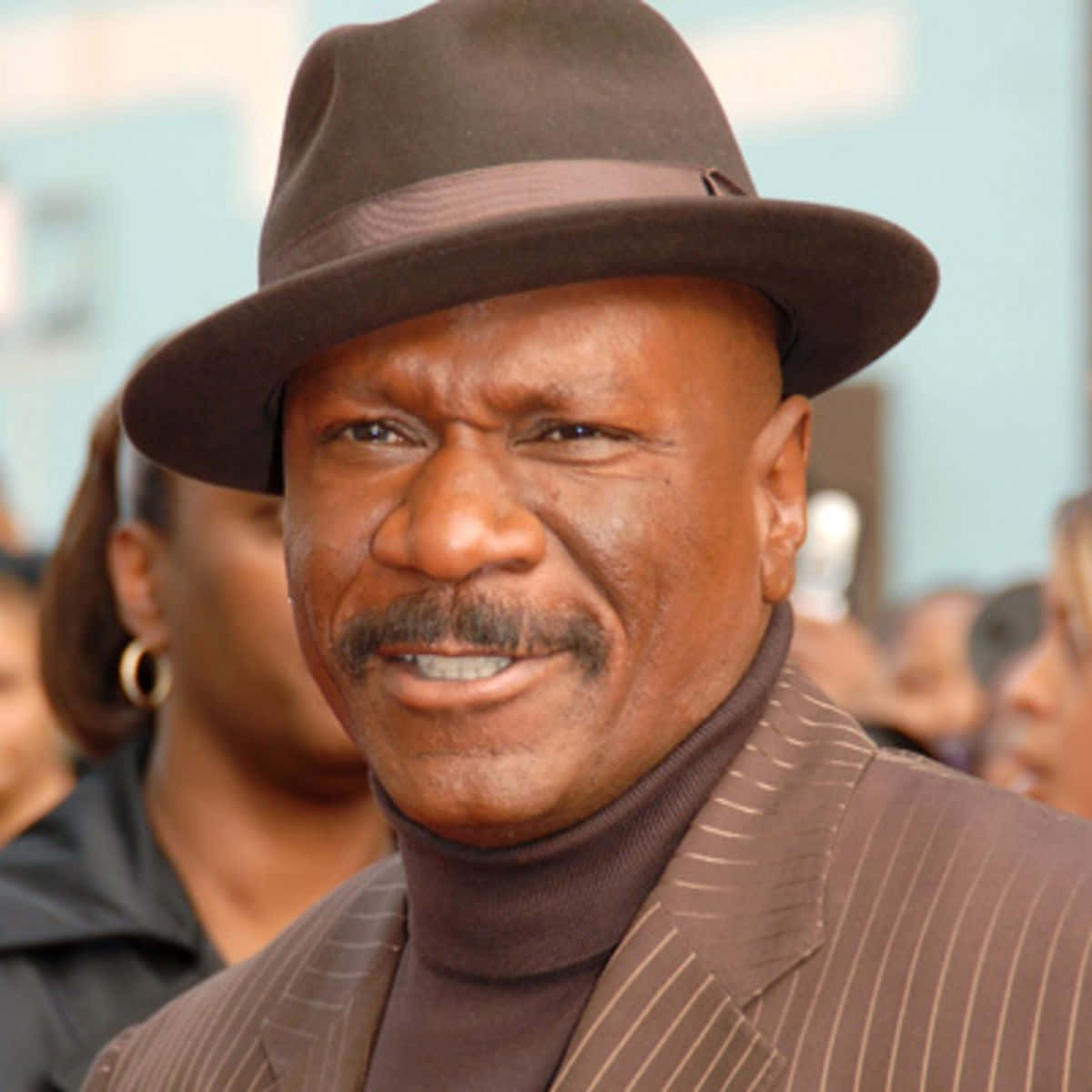 Ving Rhames Strikes A Confident Pose Against A Vivid Colorful Backdrop. Background