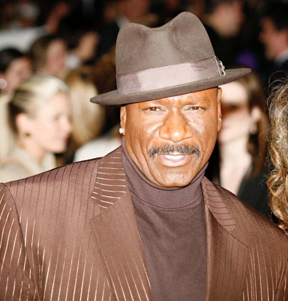 Ving Rhames Striking A Pose In A Black Suit Background