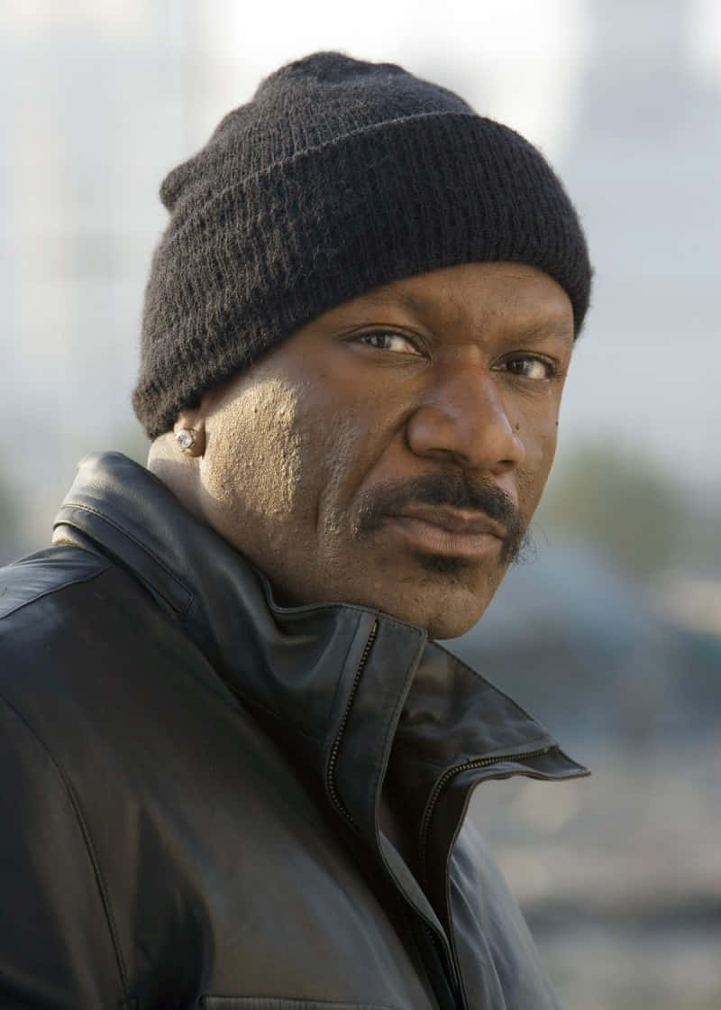 Ving Rhames Striking A Pose In A Stylish Outfit Background