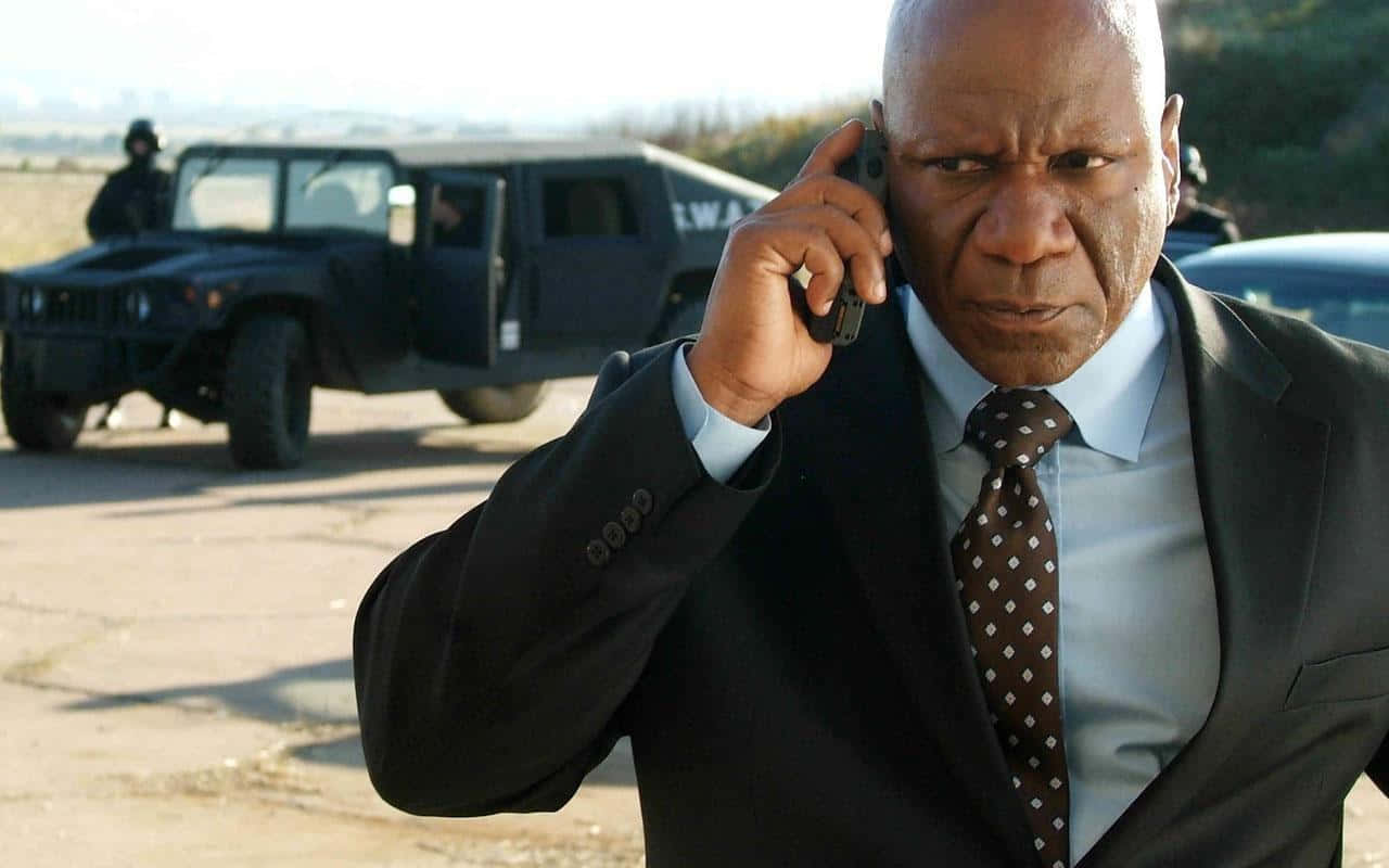 Ving Rhames Striking A Pose In A Stylish Outfit Background