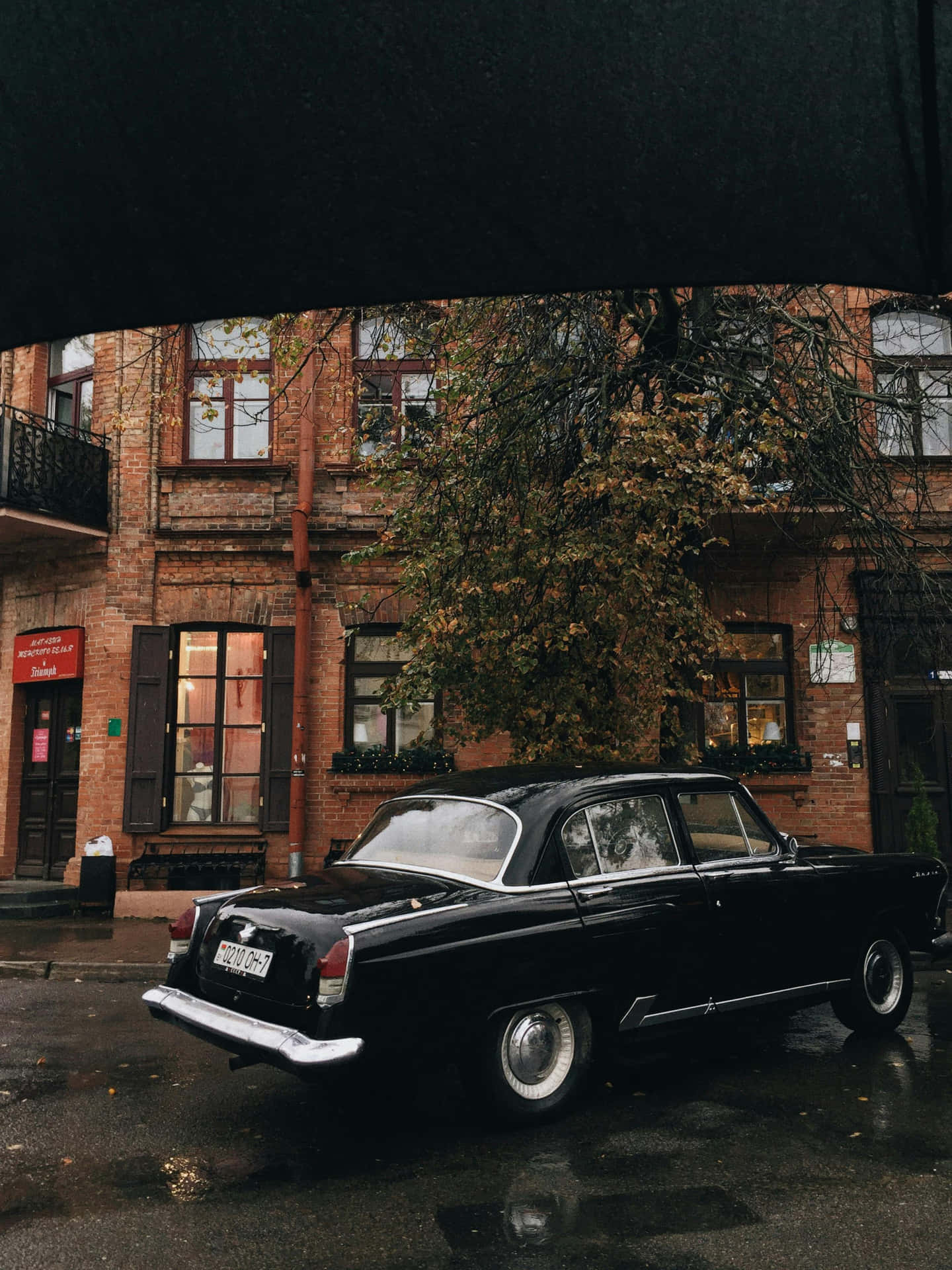 Vintage Black Car Rainy Street Scene