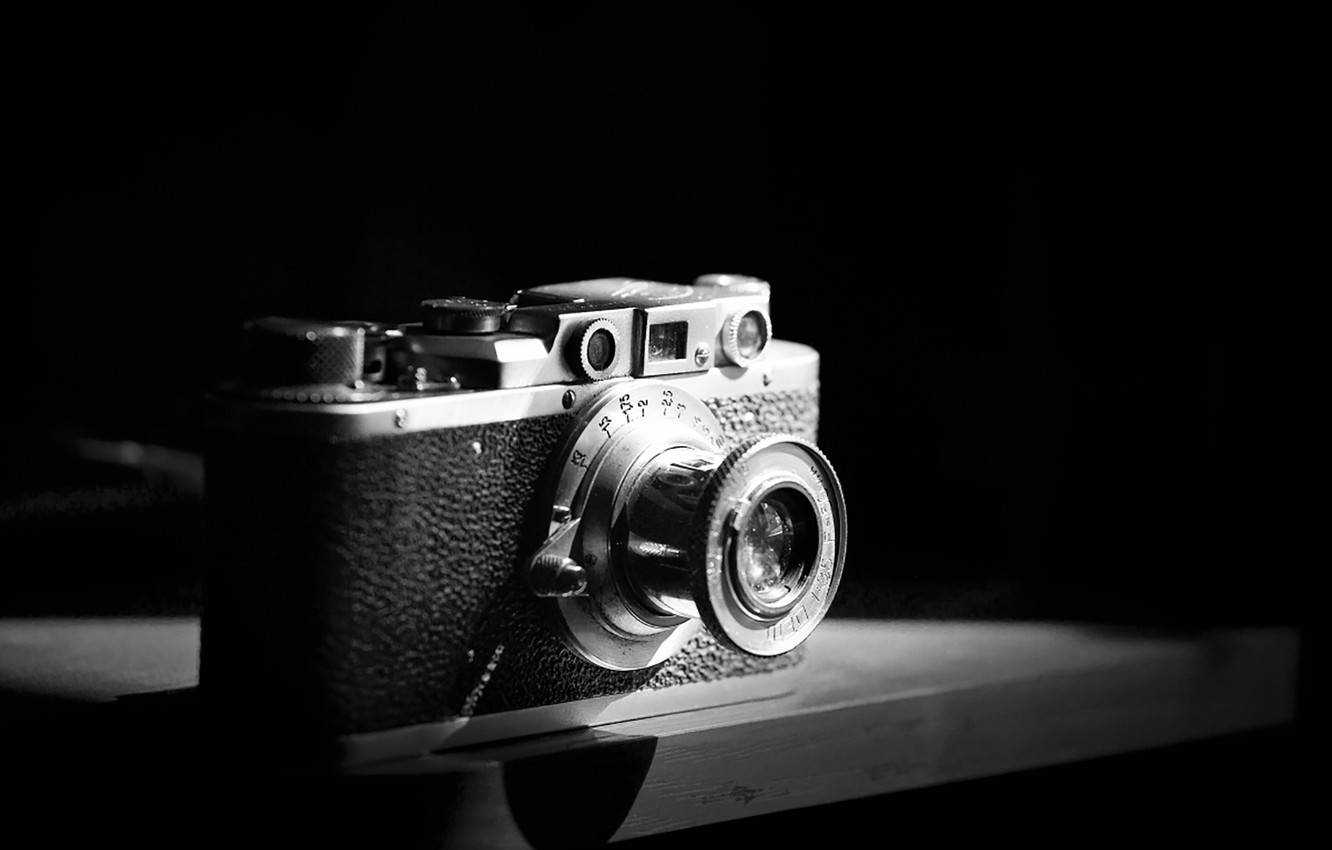 Vintage Camera - A Classic Journey Through Time In Black And White Background