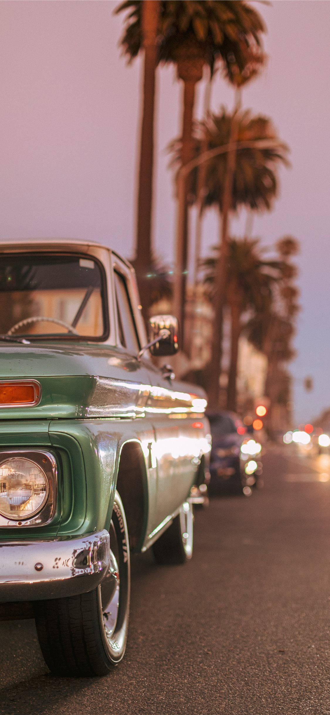 Vintage Car Parked By Palm Trees Background