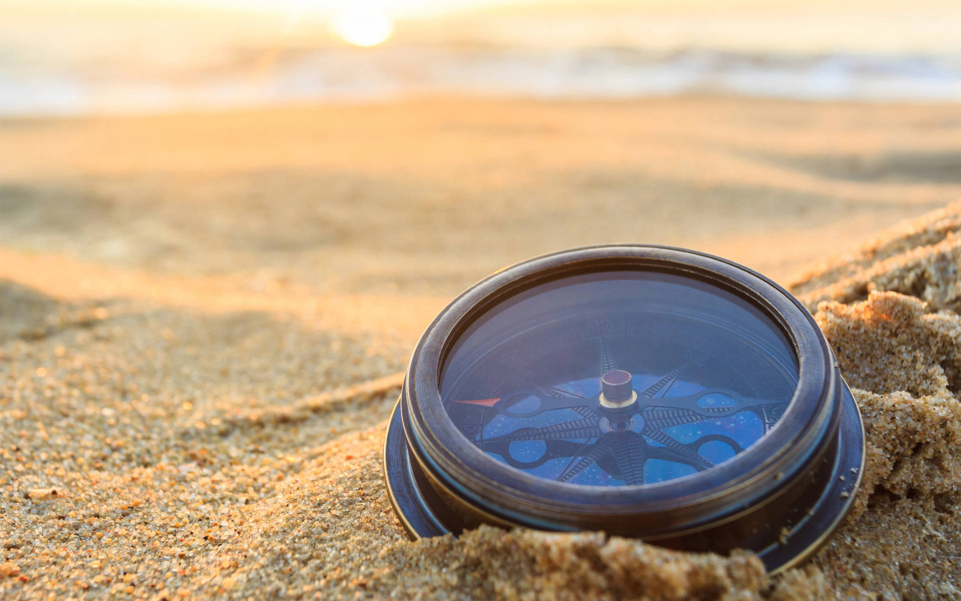 Vintage Compass On The Sand Background