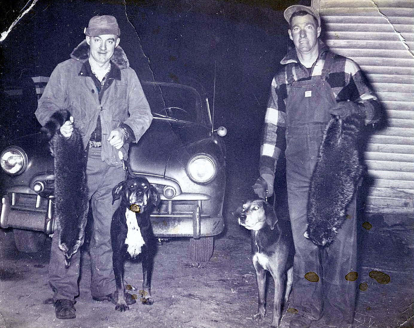 Vintage Coon Hunters With Trophiesand Dogs Background