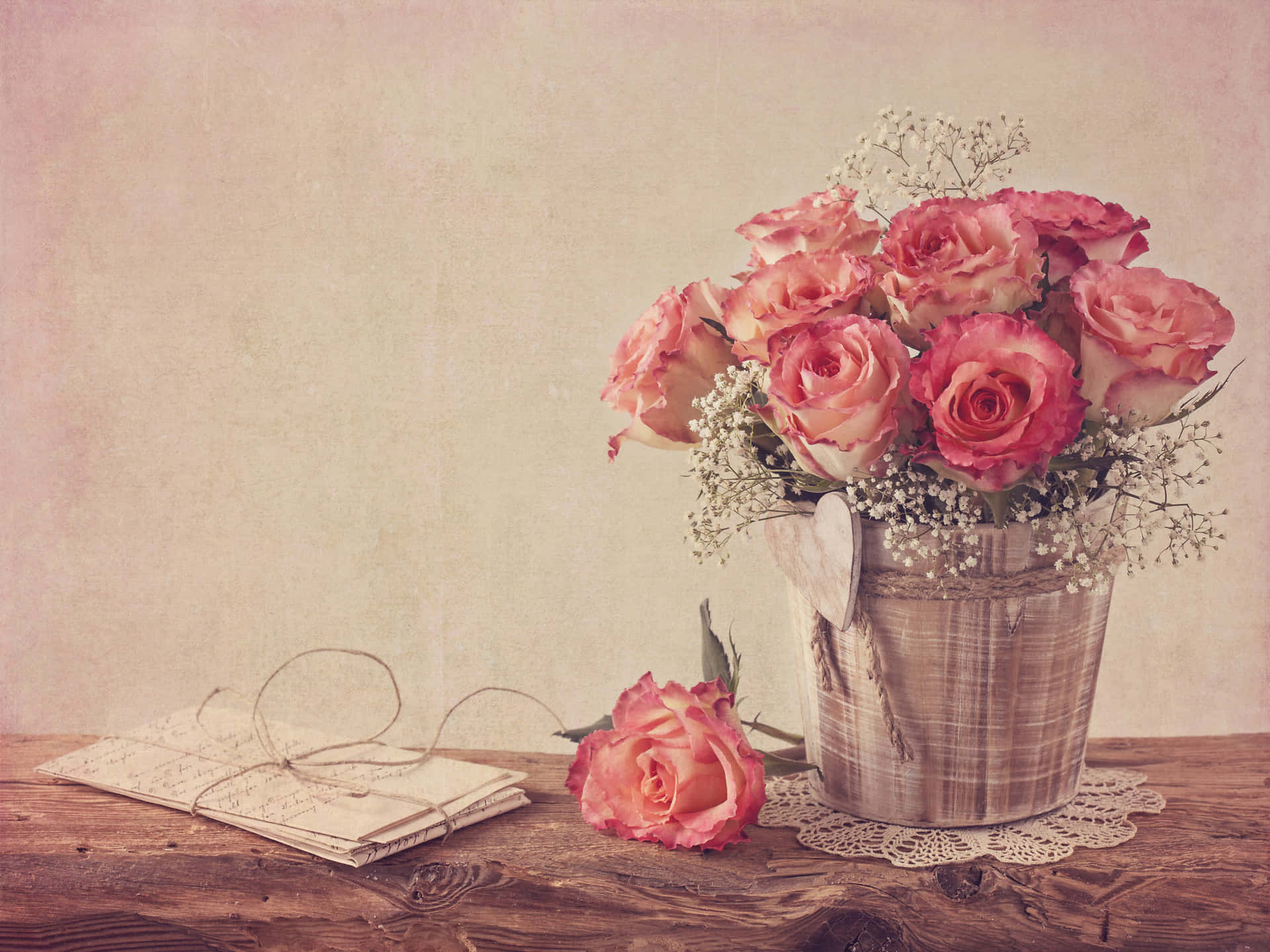 Vintage Roses In A Vase On A Wooden Table Background