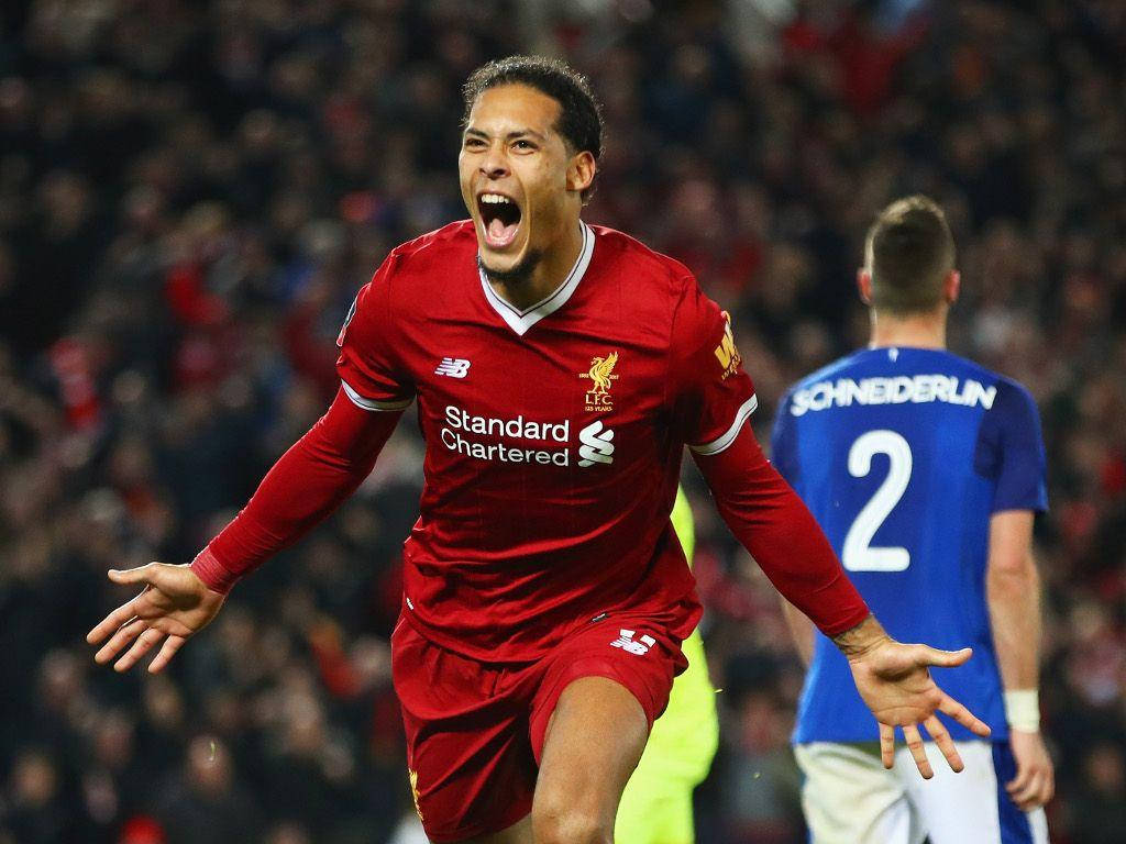 Virgil Van Dijk Roaring In Red Liverpool Fc Jersey Background