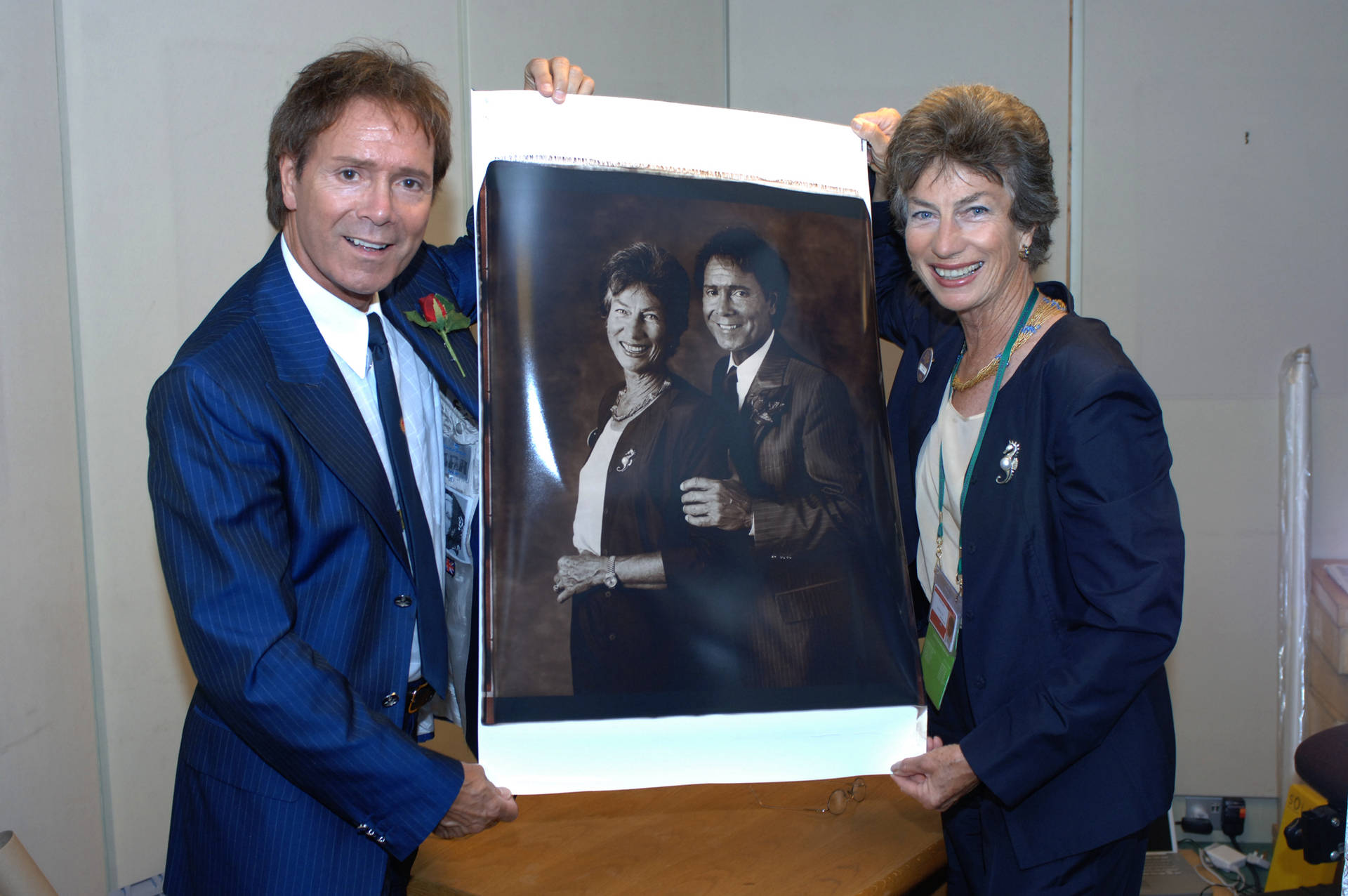 Virginia Wade And Cliff Richard At A Tennis Event Background