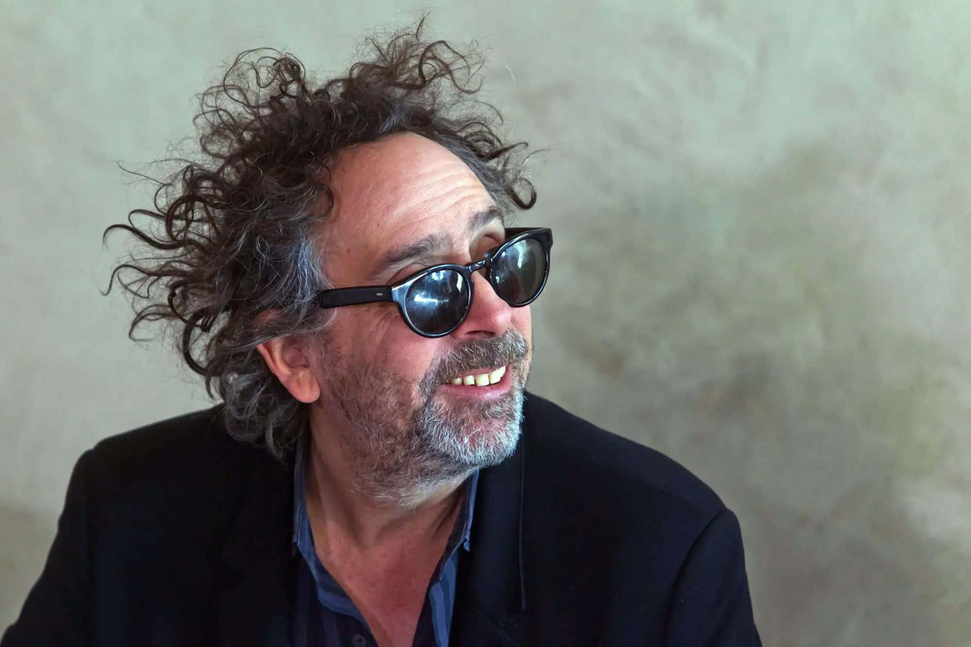 Visionary Tim Burton Immersed In His Eccentric Cinematic World Background