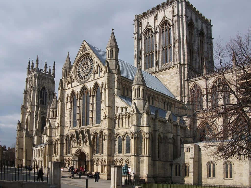 Visitors Entering The Historic York Minster Cathedral Background