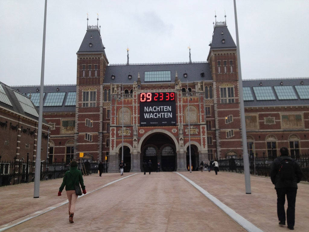 Visitors Exploring The Rijksmuseum Entrance Background