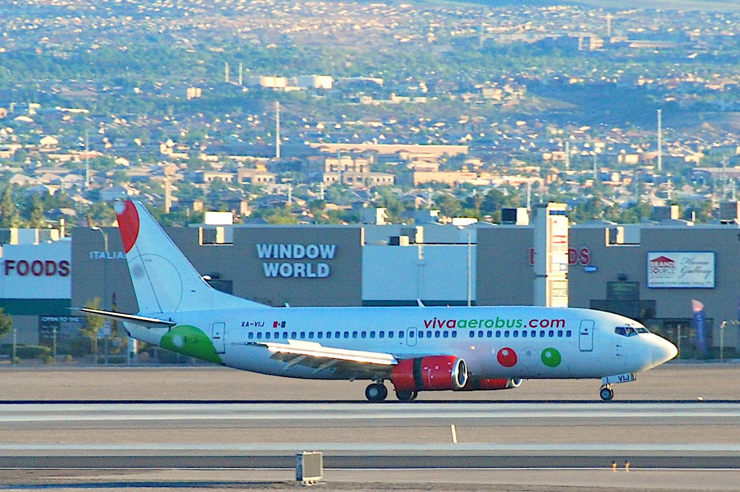 Viva Aerobus Airplane Against A Cityscape Background