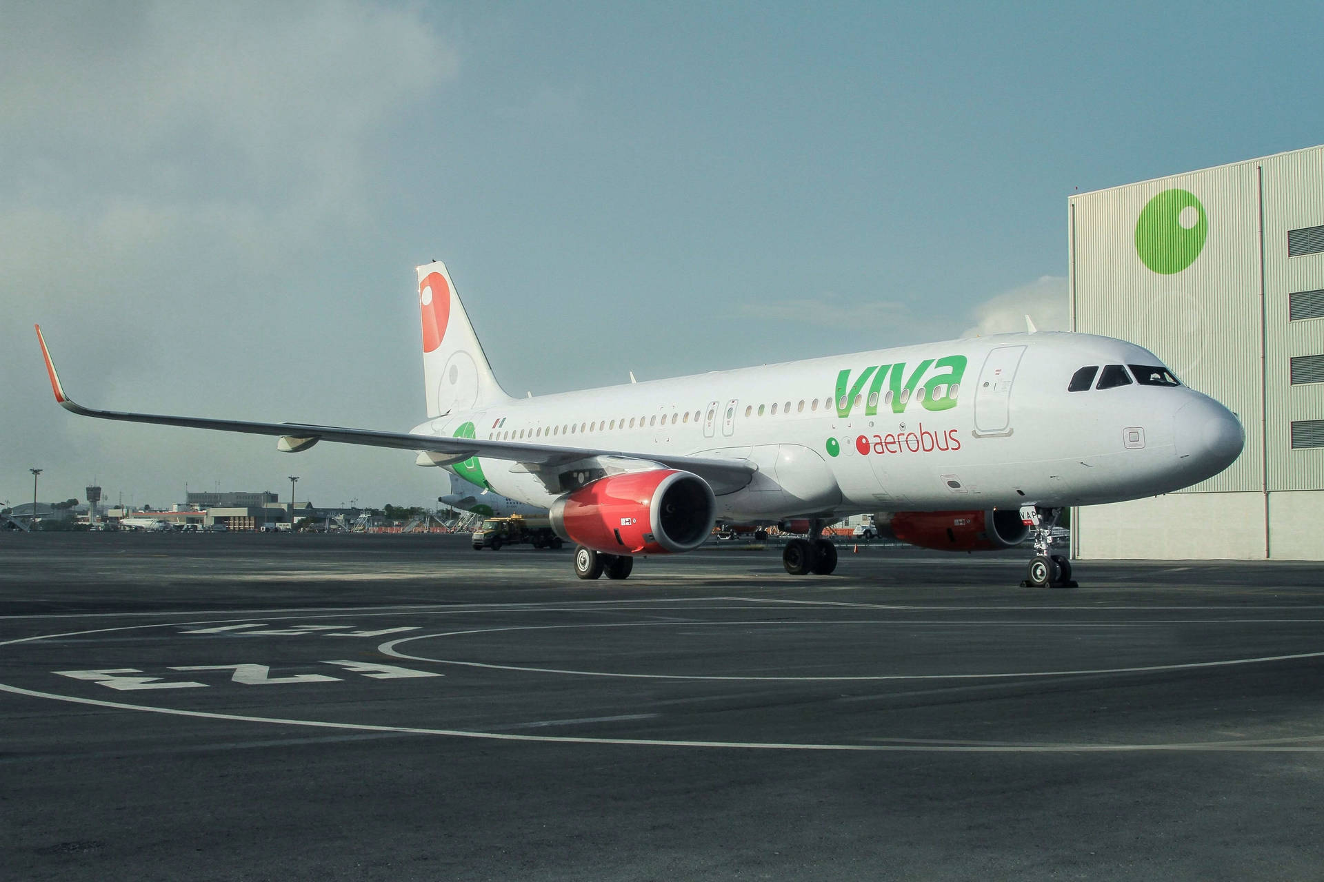 Viva Aerobus Next To Airport Building Background