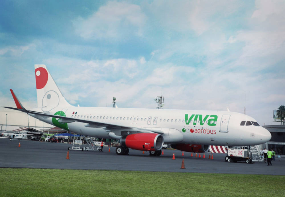 Viva Aerobus On Grass Runway Under Sky Background