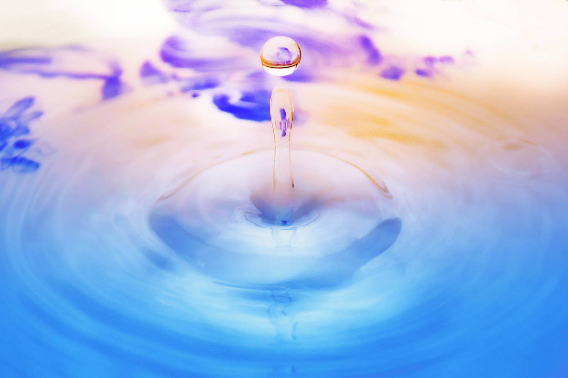 Vivid Strains Of Life: A Colorful Water Droplet