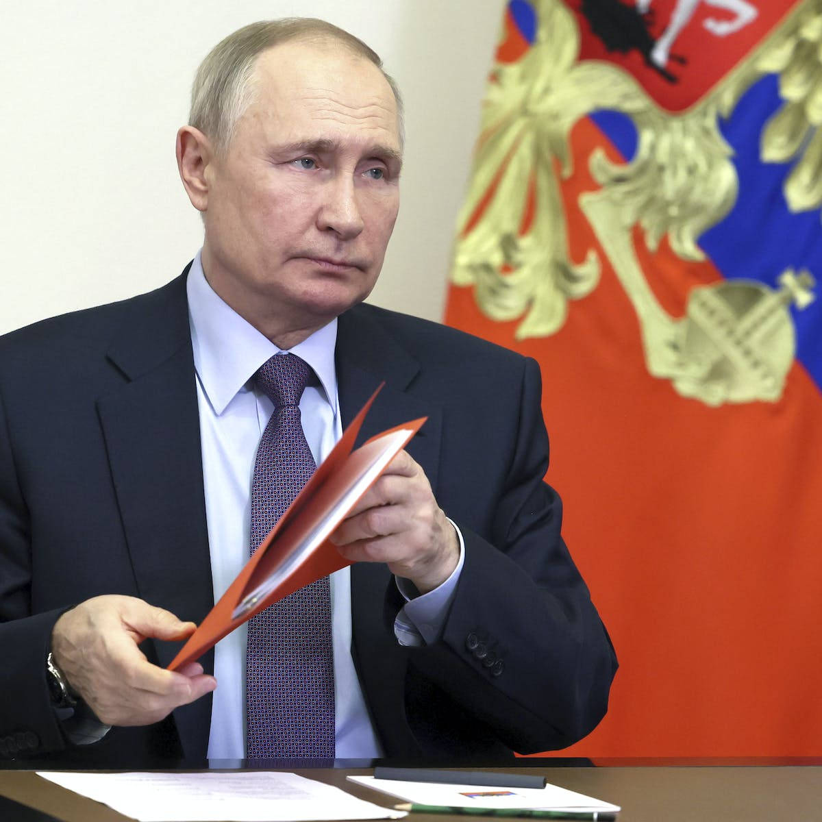 Vladimir Putin Holding A Paper Folder Background